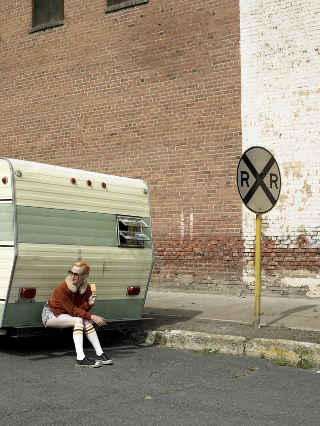 woman eating ice cream on trailer bumper