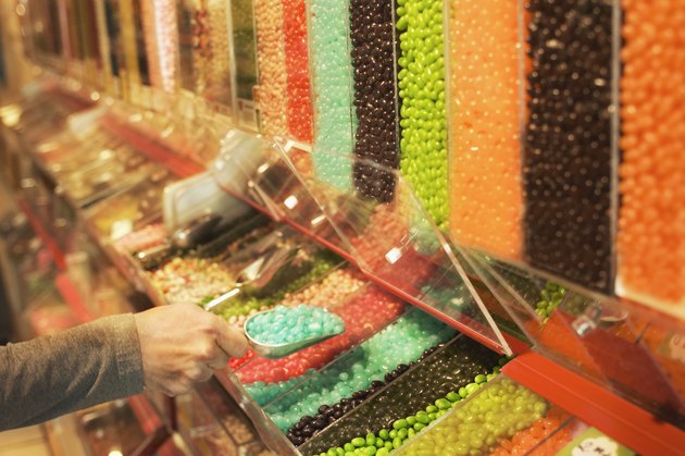 Woman scooping jelly beans in candy store