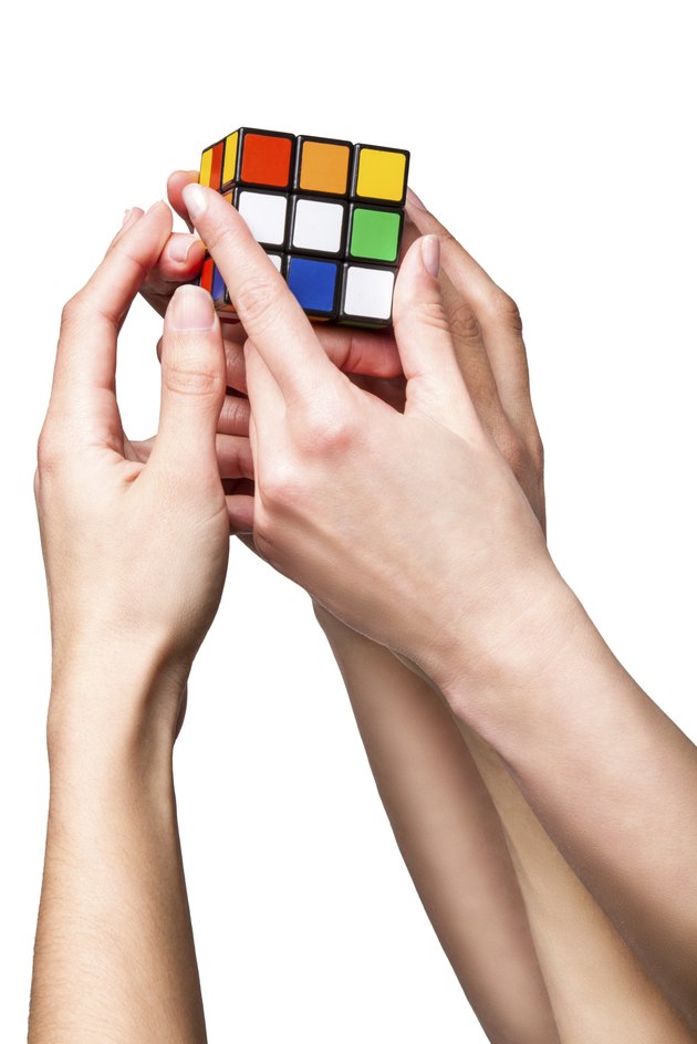 Hands holding color cube
