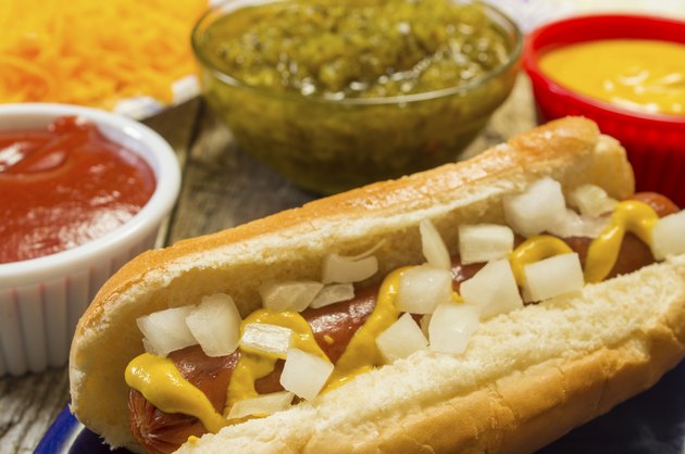 fresh grilled hot dog with mustard and onions