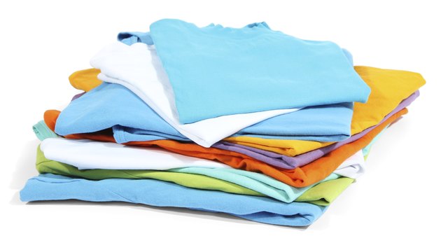 Neatly folded shirts isolated on white