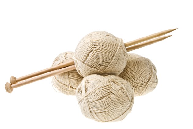 Knitting balls and knitting needles isolated on white.
