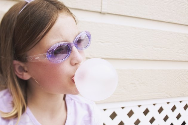 Girl blowing bubble with gum