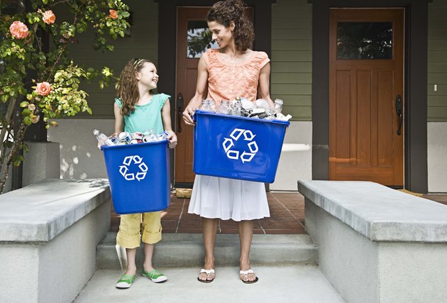 Mother and daughter recycling