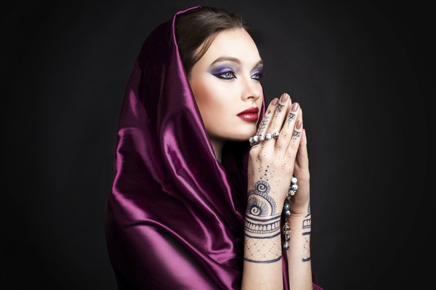 beautiful woman in oriental style with mehendi in hijab