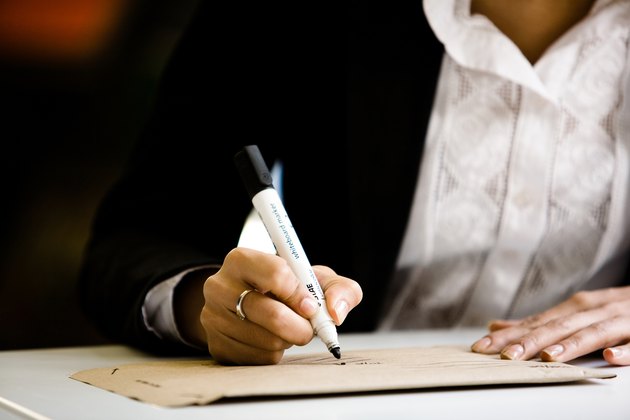 Woman addressing envelope at her desk