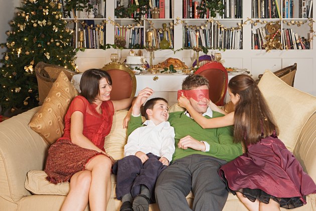 Family playing on sofa at Christmas