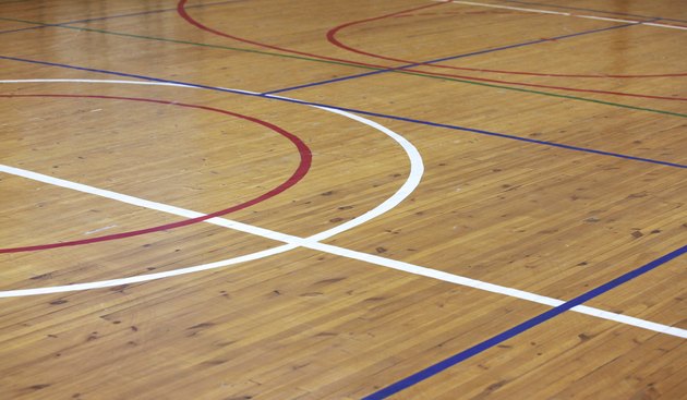 Wooden floor of sports hall with marking lines