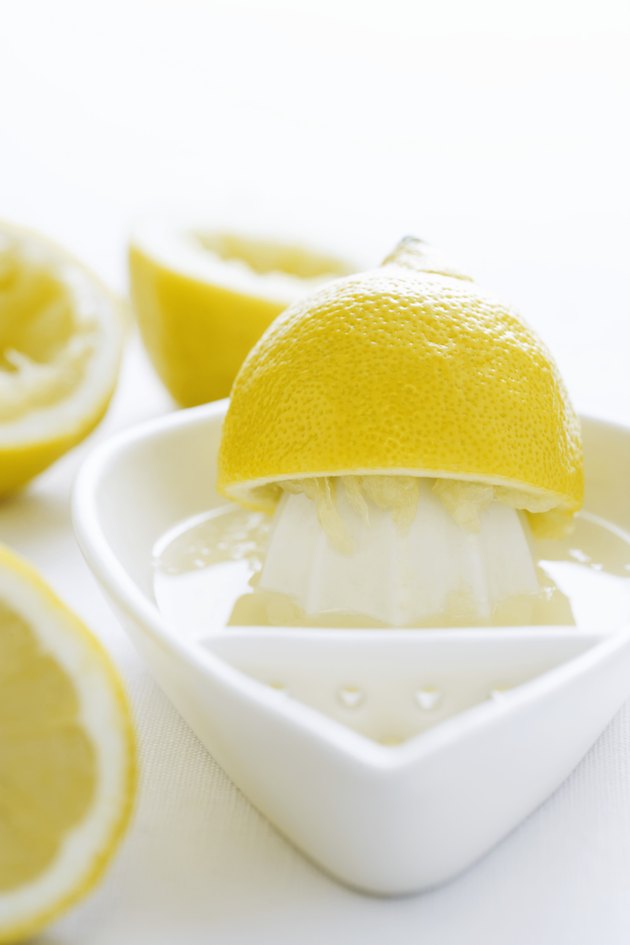 Lemon half and juice squeezer, close-up