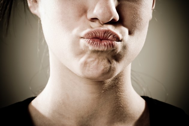 Face of teenage girl with lips pursed