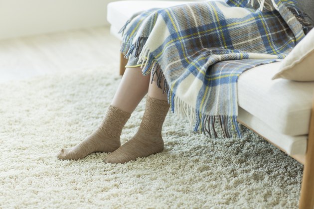 The pregnant woman who sits down on a sofa