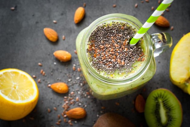 Green smoothie from fruit, leaves and seeds. A healthy eating and detox concept.