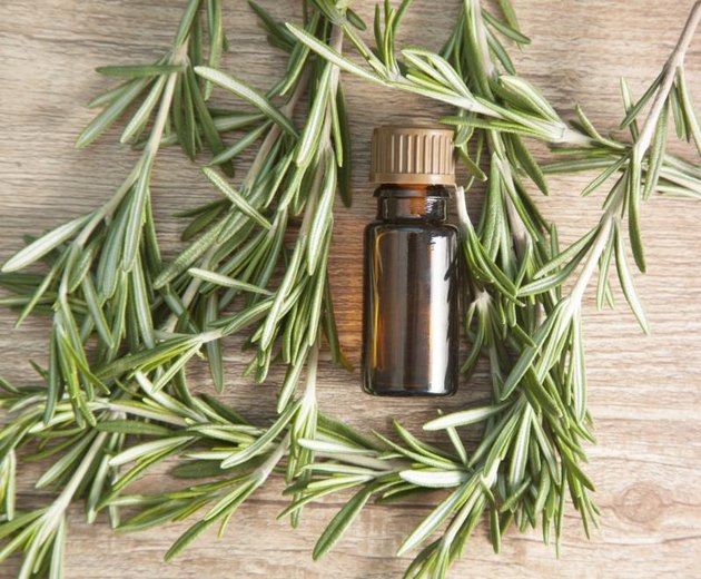 aromatic oil of rosemary on a wooden table