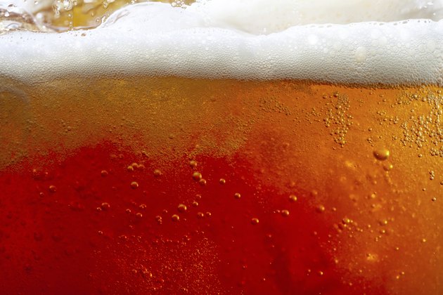 pouring beer with bubbles and froth