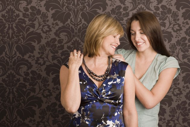 Daughter helping mother get dressed