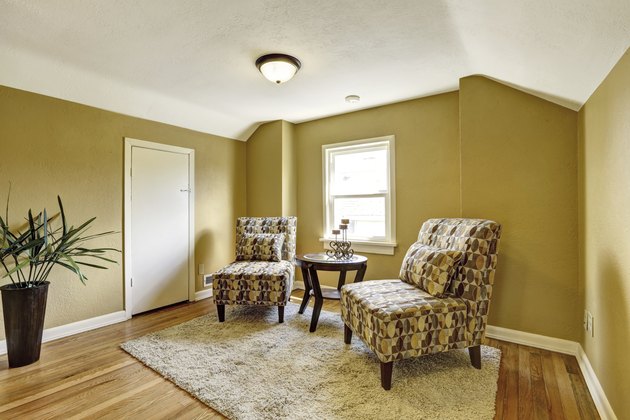 Simple room interior with two colorful chairs and table