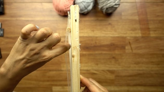 Using a round dowel as a shed stick for weaving on DIY simple frame loom.