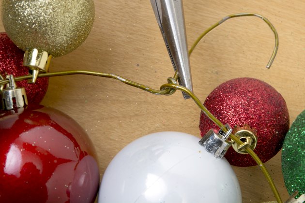 How to Make a Christmas Wreath out of a Coat Hanger by Putting Christmas Balls on It | eHow