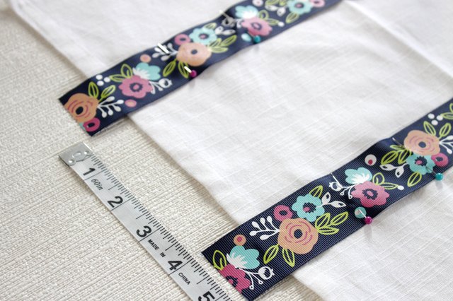 Instead of just hanging your towel over a cupboard door or throwing it on the counter, add a little ribbon to the top so you can give it a place of honor in your kitchen and hang it from your oven door.
