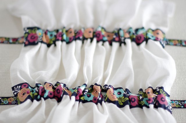 Instead of just hanging your towel over a cupboard door or throwing it on the counter, add a little ribbon to the top so you can give it a place of honor in your kitchen and hang it from your oven door.