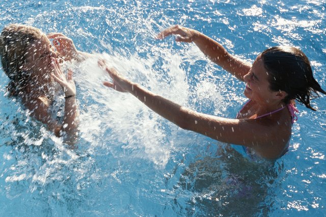 Two teenage girls (14-17) playing in water, elevated view