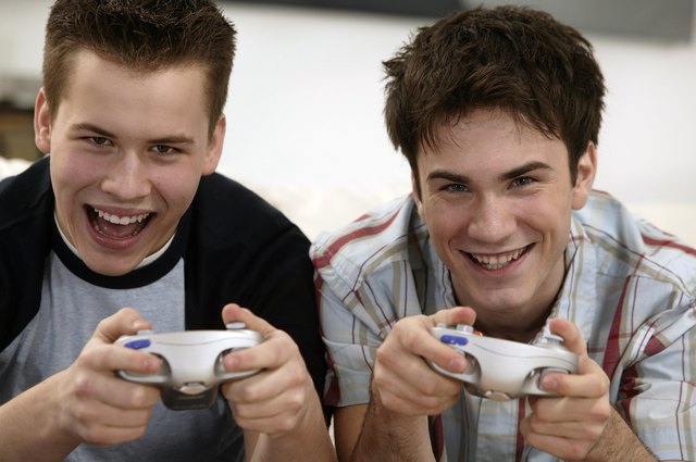 Teenage boys playing video games