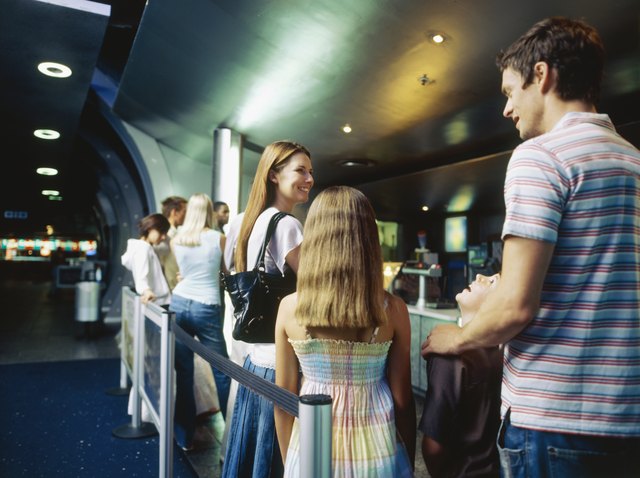 Large group of people standing in a queue inside a cinema