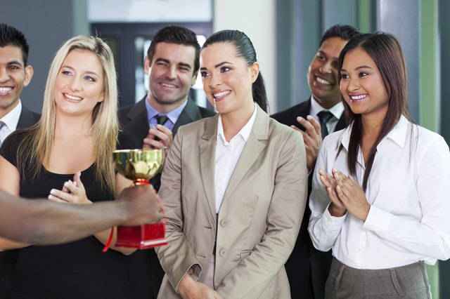 businesswoman receiving a trophy