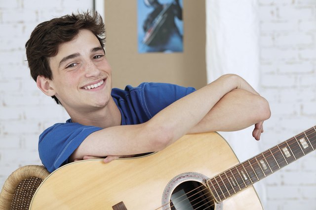 Teenage boy with acoustic guitar
