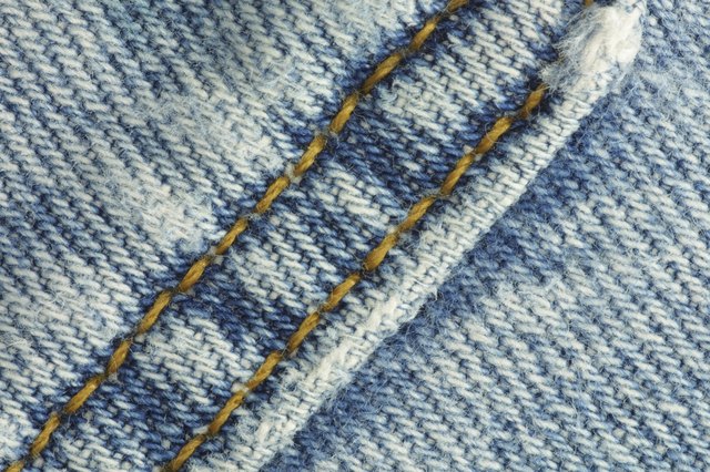the texture of the denim is stitched with orange thread, texture, jeans  closeup Stock Photo