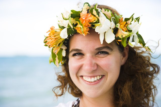 Portrait of a woman wearing a wreath of flowers and smiling, Tahaa, Tahiti, French Polynesia