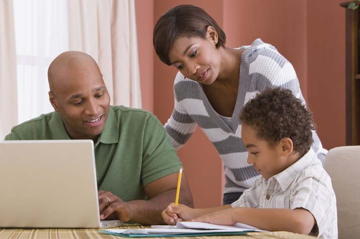 Parents helping son with homework