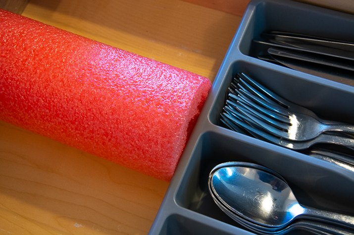 use a pool noodle to keep a drawer organized