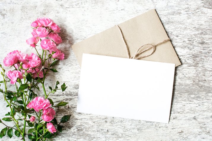 Blank white greeting card and envelope with pink rose flowers