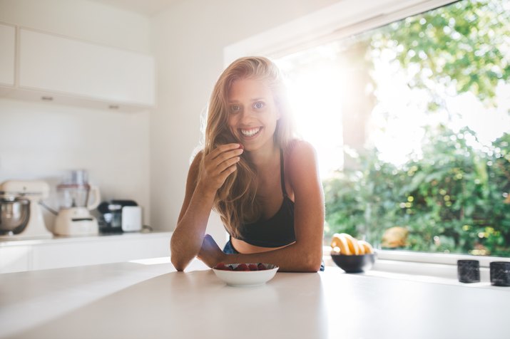 Young woman eating healthy breakfast