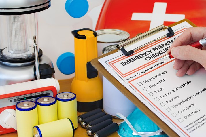 Hand completing Emergency Preparation List by Equipment