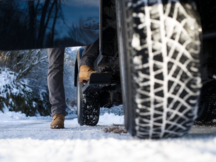 Ground view of a jeep tyre on a snow-covered road