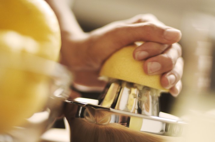 A woman juices a lemon by hand, Switzerland, Europe.