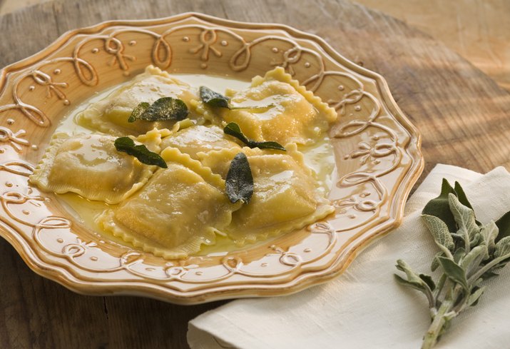 Plate of ravioli with sage and butter, studio shot