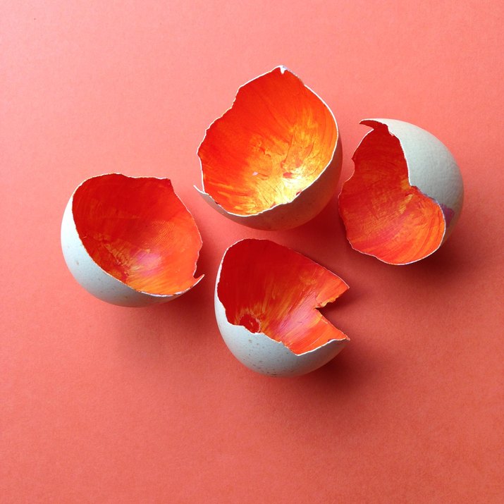 Cracked egg shells painted orange on the inside