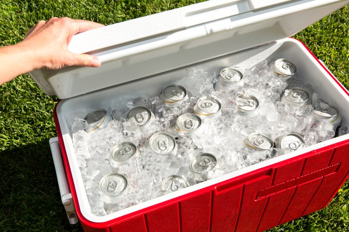 Red cooler filled with beverage cans