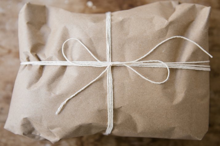 String tied around package wrapped in brown paper