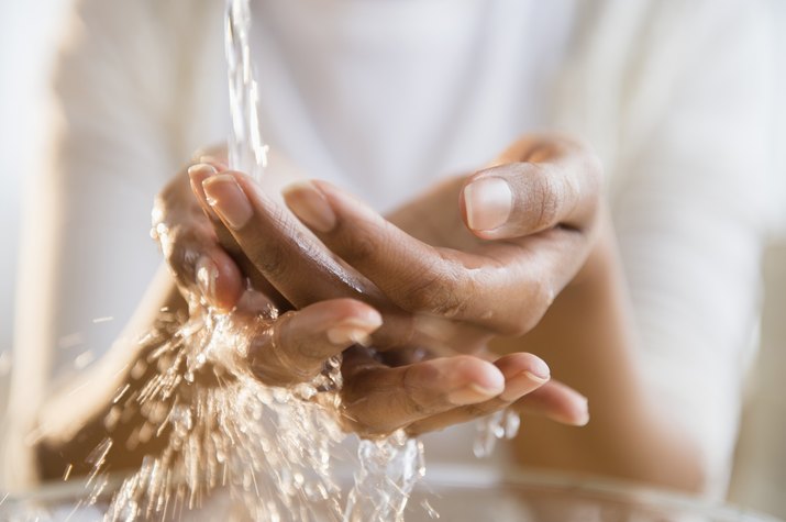 Mixed race woman washing her hands