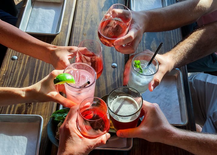 Overhead view of six people making a celebratory toast