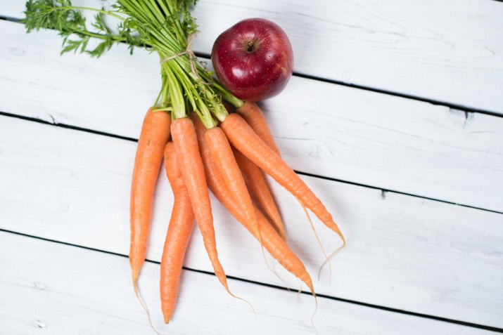 Carrot with apple on white board