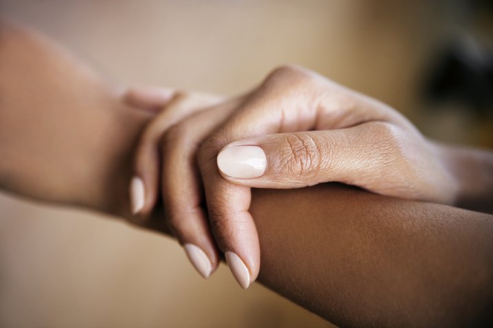 Cropped image of woman touching hand
