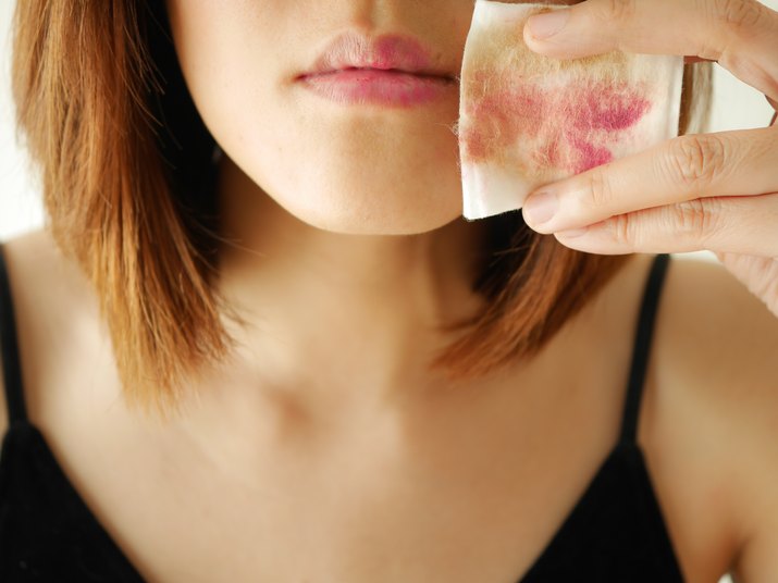 young woman remove make up by cotton pad and  cleansing wipe on face, lips,eyes.