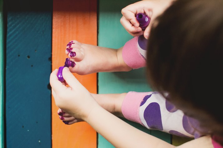 Elevated view of a girl messily painting her toes