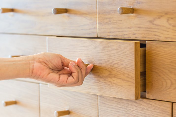 Cropped Hand Of Person Opening Drawer