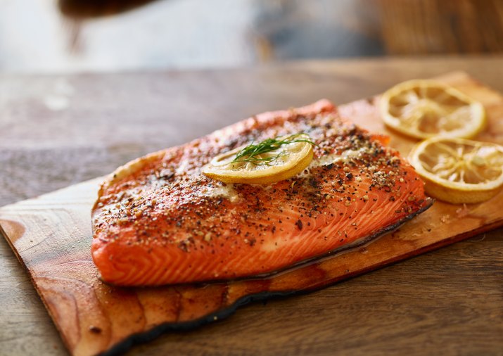 cooked cedar planked salmon with lemon and dill